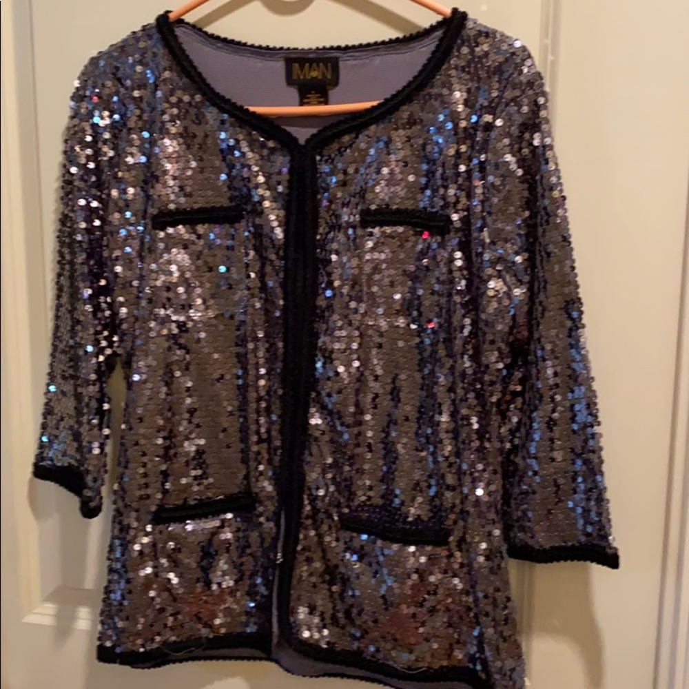 It’s an IMAN Dress jacket or blouse.